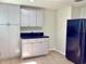 Kitchen with clean white cabinets, black countertop, and modern appliances; a functional and stylish design at 4112 Cochise Ter, Sarasota, FL 34233