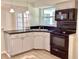 Kitchen featuring black appliances, ample cabinet space, and easy access to the dining area at 4112 Cochise Ter, Sarasota, FL 34233