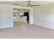 Open-concept living room with tile flooring, connecting seamlessly to dining and kitchen areas at 4112 Cochise Ter, Sarasota, FL 34233
