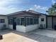 A cozy outdoor patio featuring screened-in windows, and comfortable seating area at 4122 N Lockwood Ridge Rd, Sarasota, FL 34234
