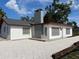 Charming white home featuring a modern gray roof and beautifully contrasted with white gravel at 4122 N Lockwood Ridge Rd, Sarasota, FL 34234