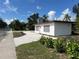 Street view of house with gravel, new landscape, windows, and gray chimney at 4122 N Lockwood Ridge Rd, Sarasota, FL 34234
