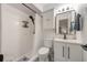 Bathroom with shower, white vanity with modern black fixtures, cabinet and shower storage at 4153 66Th Street W Cir # 4153, Bradenton, FL 34209