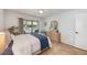 Bedroom features wood floor, ceiling fan, and a sliding glass door to screened in porch at 4153 66Th Street W Cir # 4153, Bradenton, FL 34209