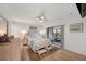Bedroom features wood floor, ceiling fan, and a sliding glass door to screened in porch at 4153 66Th Street W Cir # 4153, Bradenton, FL 34209