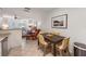 Stylish dining area adjacent to kitchen and living room features a dark wood table and four cushioned chairs at 4153 66Th Street W Cir # 4153, Bradenton, FL 34209