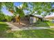 Charming corner home featuring a landscaped yard, mature trees, and a screened-in porch for relaxing outdoors at 4153 66Th Street W Cir # 4153, Bradenton, FL 34209