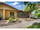 Charming home exterior featuring beautiful landscaping, a bench, and sidewalk to the front door at 4153 66Th Street W Cir # 4153, Bradenton, FL 34209