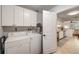 Bright laundry room area with washer and dryer; white cabinets providing ample storage space at 4153 66Th Street W Cir # 4153, Bradenton, FL 34209