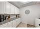 Pantry features granite countertop, white cabinets and drawers, and stainless steel hardware at 4153 66Th Street W Cir # 4153, Bradenton, FL 34209
