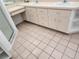 Bathroom with double sinks, tile flooring, and neutral cabinetry at 4354 Rock Creek Dr, Port Charlotte, FL 33948