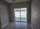 Cozy dining area with neutral walls, tile floors, and sliding glass doors that open to the backyard at 4354 Rock Creek Dr, Port Charlotte, FL 33948