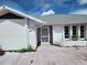 Front exterior of home with a purple front door and lush vegetation around the perimeter at 4354 Rock Creek Dr, Port Charlotte, FL 33948