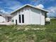 A detached garage with a white exterior, a roll-up door, and two narrow windows at 4354 Rock Creek Dr, Port Charlotte, FL 33948