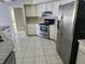 Light and airy kitchen with stainless steel appliances, white cabinets, and tile flooring at 4354 Rock Creek Dr, Port Charlotte, FL 33948