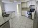 Open kitchen with granite countertops, stainless steel appliances, and tile flooring at 4354 Rock Creek Dr, Port Charlotte, FL 33948