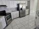 Bright kitchen with stainless steel appliances, white cabinets, and tile flooring at 4354 Rock Creek Dr, Port Charlotte, FL 33948