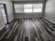 Comfortable living room with modern floors, large windows, and a sliding glass door allowing ample natural light at 4354 Rock Creek Dr, Port Charlotte, FL 33948