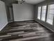 Bright living room with updated floors, neutral walls, and large windows providing plenty of natural light at 4354 Rock Creek Dr, Port Charlotte, FL 33948