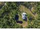 Wide aerial view of a secluded home on a large lot with a private pond surrounded by lush greenery at 4888 Old Ranch Rd, Sarasota, FL 34241
