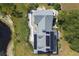 Aerial view of a home featuring solar panels, a long walkway, and a pond next to the property at 4888 Old Ranch Rd, Sarasota, FL 34241