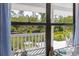 Scenic view from the balcony overlooking a lush backyard and tranquil pond, perfect for enjoying nature at 4888 Old Ranch Rd, Sarasota, FL 34241