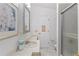 Bright bathroom featuring a sleek vanity, framed mirror, and a glass-enclosed shower at 4888 Old Ranch Rd, Sarasota, FL 34241