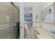 This bathroom provides a gateway view into a bedroom boasting a large bookshelf at 4888 Old Ranch Rd, Sarasota, FL 34241