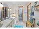 Well-decorated bathroom featuring a vanity, statement mirror, with a glimpse of the shower at 4888 Old Ranch Rd, Sarasota, FL 34241
