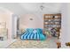 Inviting bedroom with pastel walls, slanted ceiling, cozy rug, comfy bed, and a bookshelf displaying decorative items at 4888 Old Ranch Rd, Sarasota, FL 34241