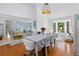 Dining room with large window, hardwood floors, and staircase view at 4888 Old Ranch Rd, Sarasota, FL 34241