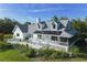 Beautiful white home with a porch, complimented by a well-manicured lawn and landscaping at 4888 Old Ranch Rd, Sarasota, FL 34241