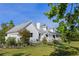 Exterior of a charming home with a covered porch and well-maintained yard surrounded by lush greenery at 4888 Old Ranch Rd, Sarasota, FL 34241