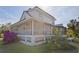 Spacious screened-in porch perfect for enjoying the outdoors, complemented by well-manicured landscaping at 4888 Old Ranch Rd, Sarasota, FL 34241