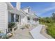 Charming two-story home with a welcoming front porch, adorned with a decorative statue and colorful landscaping at 4888 Old Ranch Rd, Sarasota, FL 34241