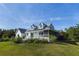 Inviting two-story home with a charming front porch, perfect for enjoying the serene surroundings at 4888 Old Ranch Rd, Sarasota, FL 34241