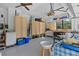 Spacious garage featuring ample cabinet storage, workbench, and natural light from a window at 4888 Old Ranch Rd, Sarasota, FL 34241