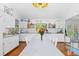 Spacious kitchen with white cabinetry, granite counters, hardwood floors, and modern appliances at 4888 Old Ranch Rd, Sarasota, FL 34241