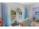 Bright living room with view to lush landscaping, pastel colors, and unique accents at 4888 Old Ranch Rd, Sarasota, FL 34241