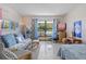 Cozy living room with a futon, study area, and ample natural light at 4888 Old Ranch Rd, Sarasota, FL 34241