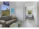 Cozy room with large windows, a comfortable couch, built-in bookcase, and a dedicated desk space, offering style and functionality at 4888 Old Ranch Rd, Sarasota, FL 34241