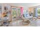 Light-filled living room featuring neutral tones, French doors, tile floors, and stylish furnishings at 4888 Old Ranch Rd, Sarasota, FL 34241