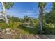Beautiful outdoor pond with fountain and wooden dock at 4888 Old Ranch Rd, Sarasota, FL 34241