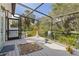 Enclosed porch showcasing a peaceful outdoor seating area with views of the home's surroundings at 4888 Old Ranch Rd, Sarasota, FL 34241