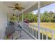 A screened porch with comfy seating offers views of lush greenery and flowers at 4888 Old Ranch Rd, Sarasota, FL 34241