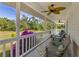 Picturesque screened porch featuring outdoor seating and views of lush greenery and vibrant flowers at 4888 Old Ranch Rd, Sarasota, FL 34241