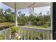 Picturesque view from the porch of a serene pond with a fountain, framed by lush greenery and a 'Paradise' sign at 4888 Old Ranch Rd, Sarasota, FL 34241