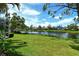 Serene backyard overlooking a tranquil lake, perfect for relaxing and enjoying nature at 5080 Timber Chase Way, Sarasota, FL 34238