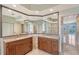 Primary bath boasting double vanity with granite countertops, soaking tub and large mirror at 5080 Timber Chase Way, Sarasota, FL 34238