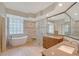 Luxury bathroom with a soaking tub, walk-in shower and and sink with stone countertops at 5080 Timber Chase Way, Sarasota, FL 34238